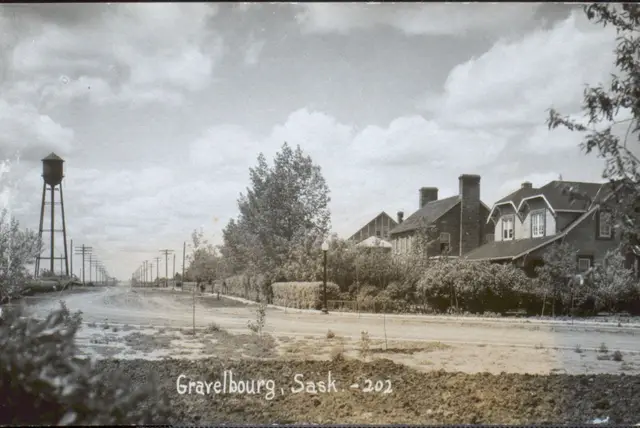 Street view with water tower and brick houses